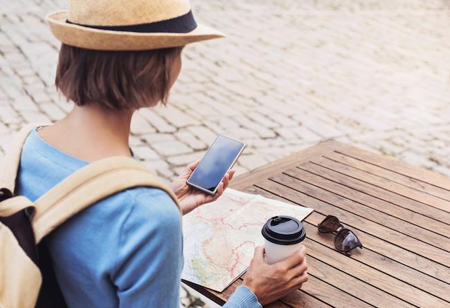 woman with phone and map